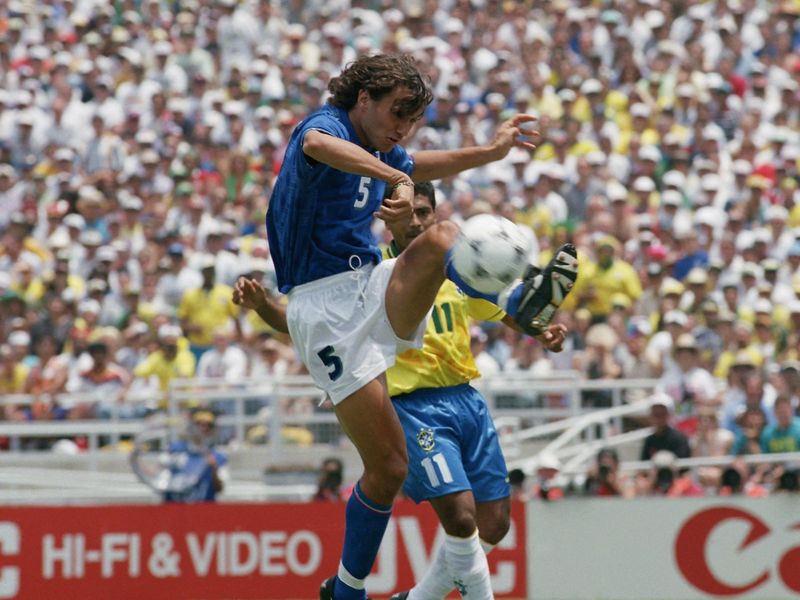 Italy's defender Paolo Maldini directs ball away from Brazil's Romario
