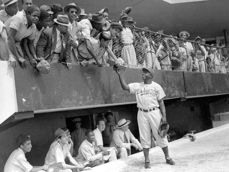 Jackie Robinson signs autographs