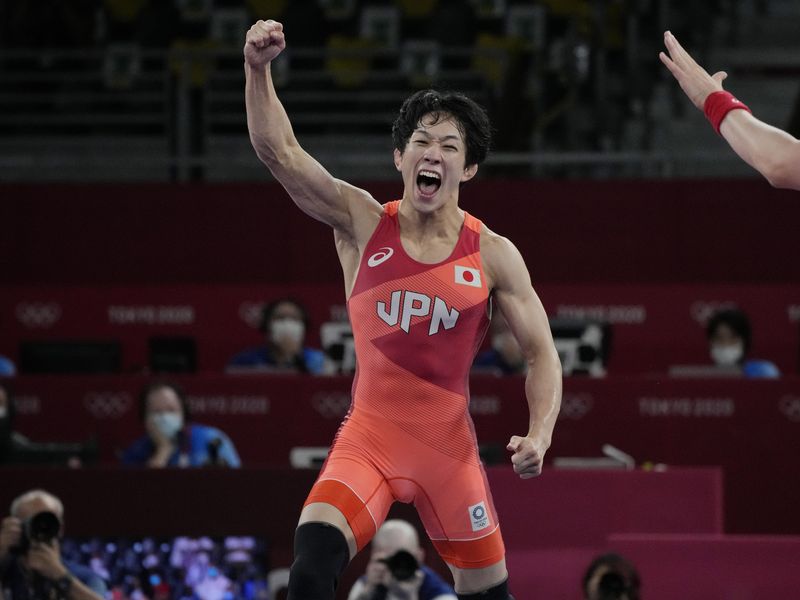 Japan's Takuto Otoguro celebrates after defeating Azerbaijan's Haji Aliyev
