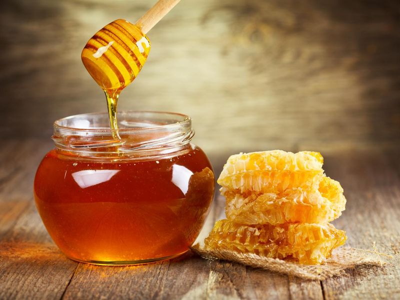 Jar of honey with honeycomb