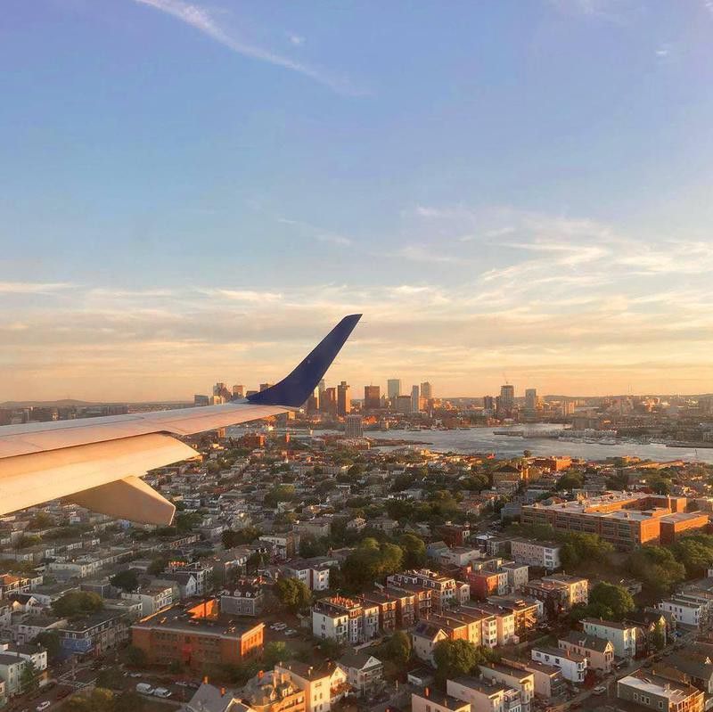 JetBlue airplane flying over Boston