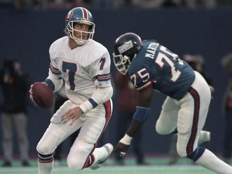 John Elway playing quarterback for Denver Broncos