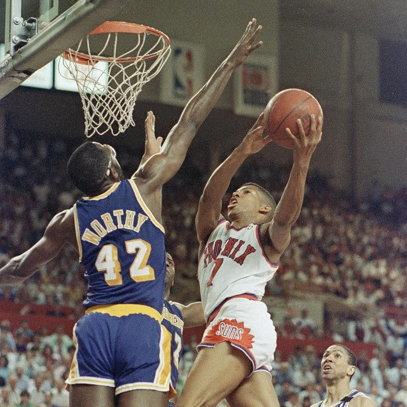 Kevin Johnson drives to basket
