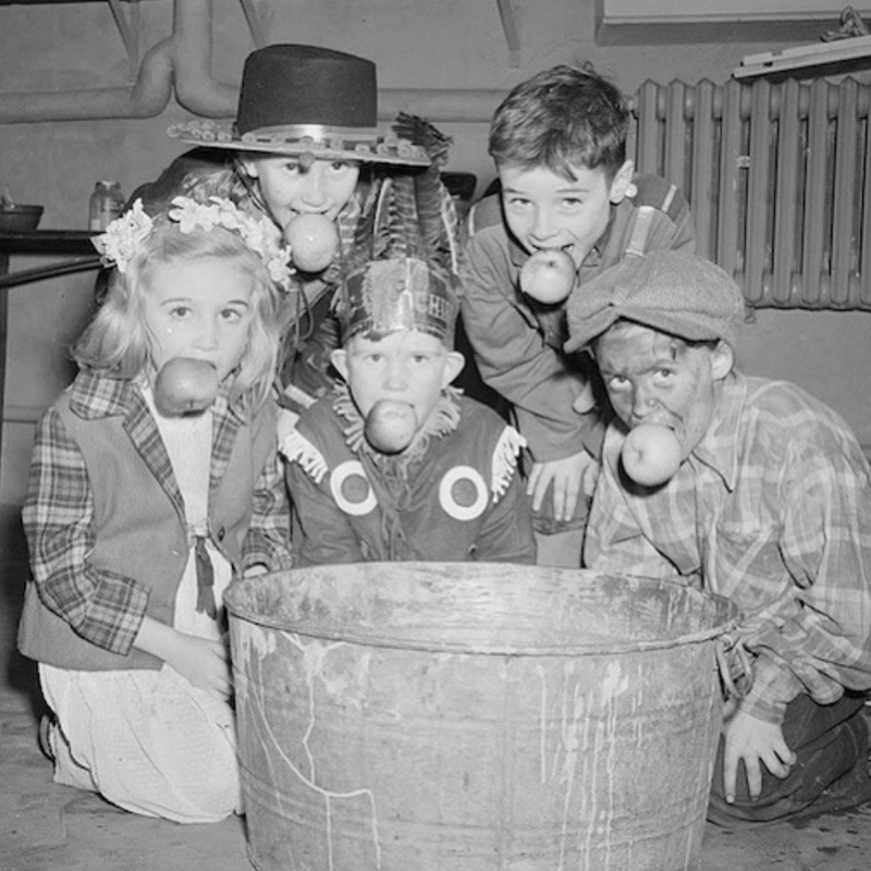 Kids bobbing for apples in the 1920s