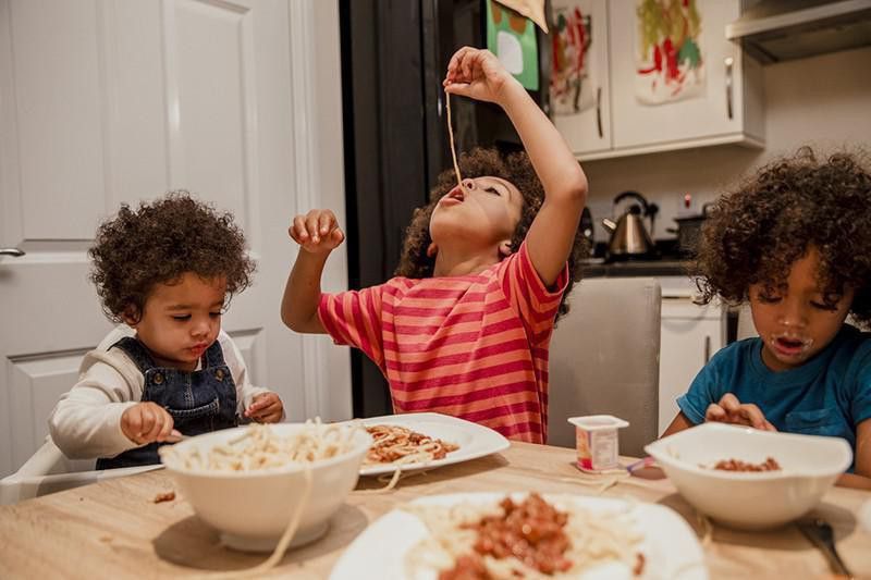 Kids eating spaghetti