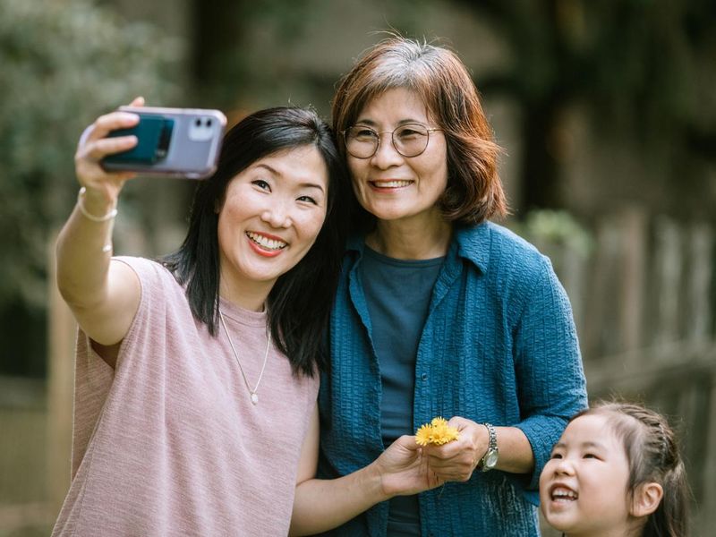 Korean family taking pictures with a phone
