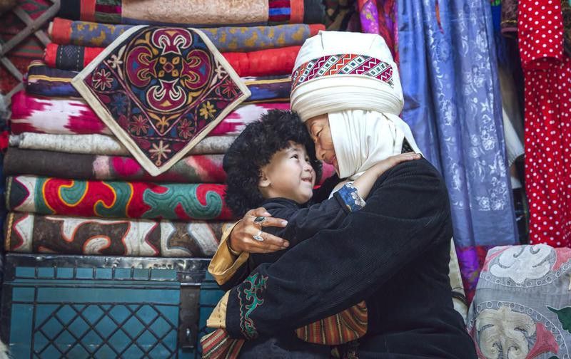Kyrgyz mother and her son in their home yurt
