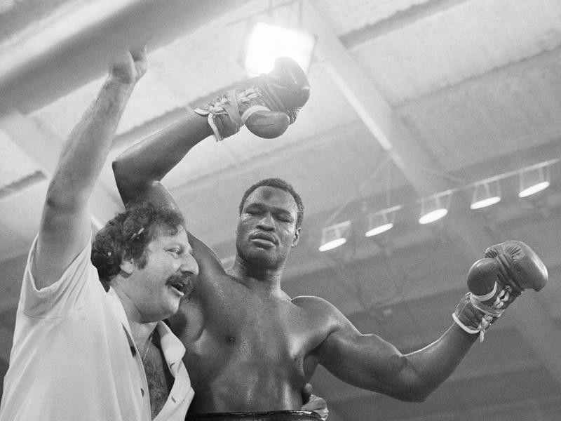 Larry Holmes embraced by manager Richie Giachetti
