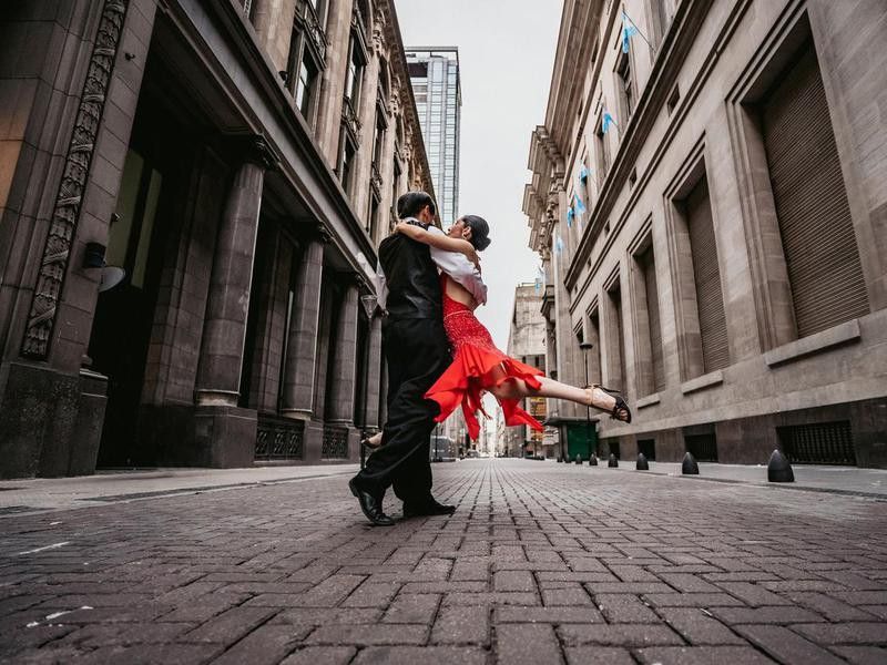 Latin couple dancing tango on city street