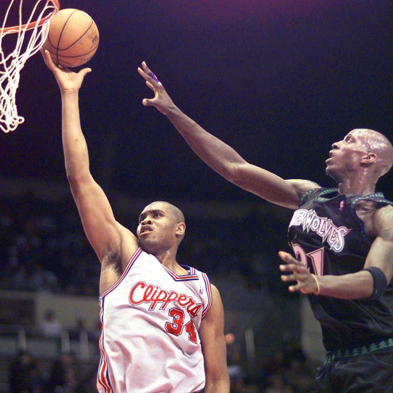 Los Angeles Clippers' Michael Olowokandi lays one into the hoop