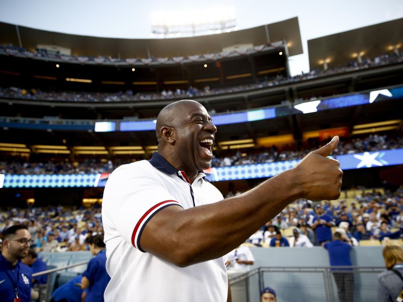 Los Angeles Dodgers' owner Magic Johnson arrives for game
