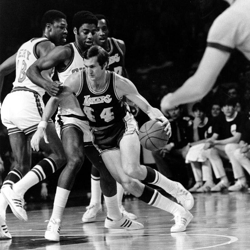 Los Angeles Lakers' Jerry West drives around Milwaukee Bucks' Oscar Robertson