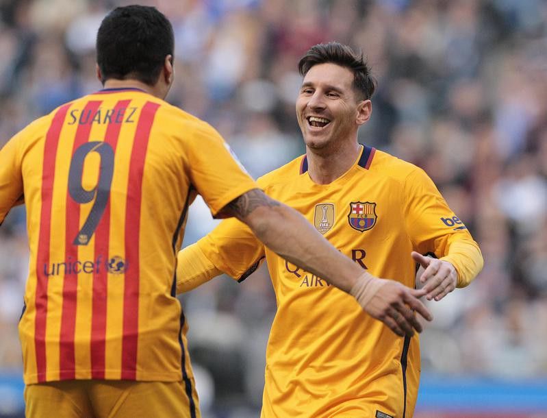 Luis Suarez is congratulated by Lionel Messi