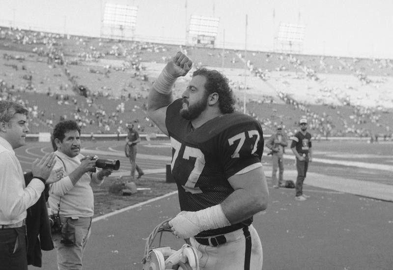 Lyle Alzado of the Los Angeles Raiders gives victory fist after beating Steelers in playoffs