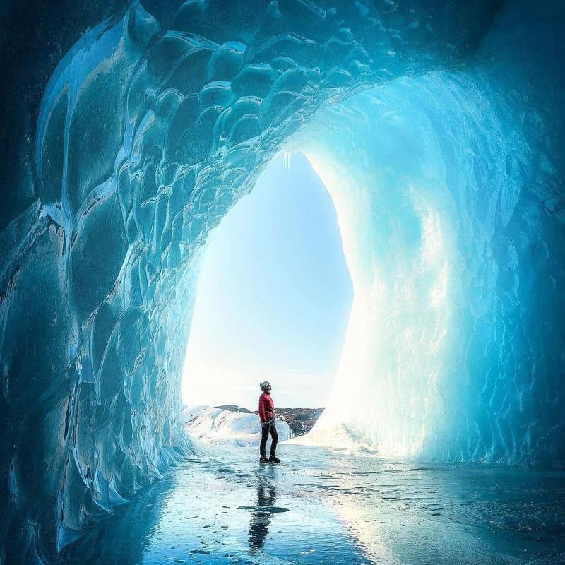 Man inside ice cave in Vatnajokull National Park, Iceland