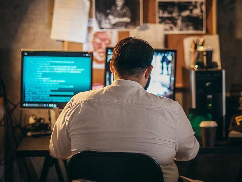 Man using computer in office at night