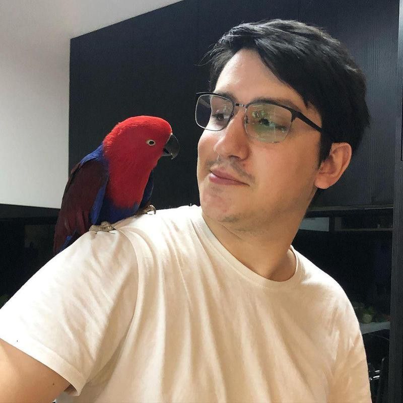 Man with his pet red bird