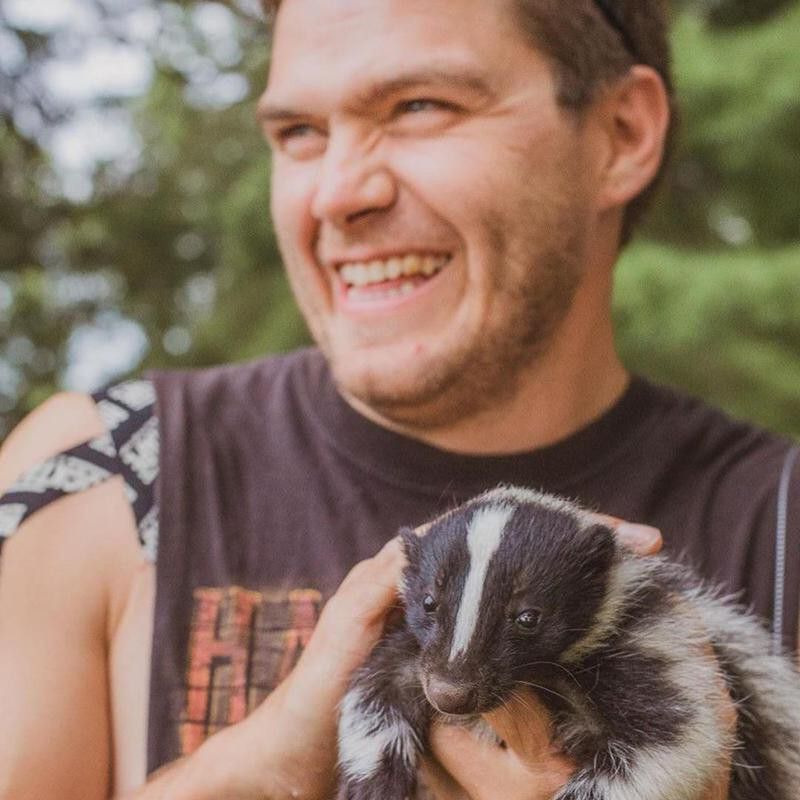 Man with pet skunk
