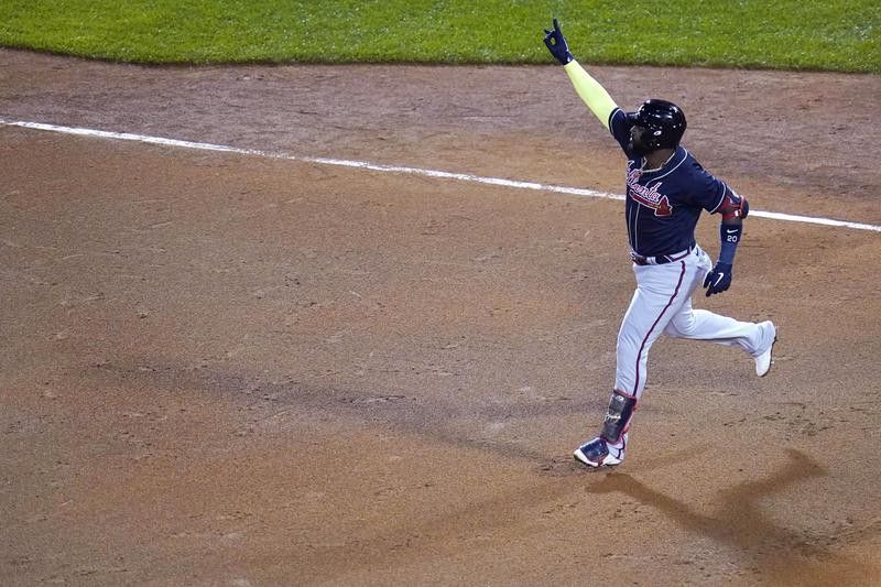Marcell Ozuna of the Atlanta Braves reacts after hitting. home run