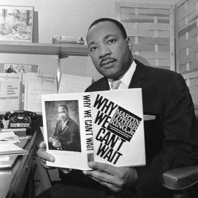 MLK posing with his book