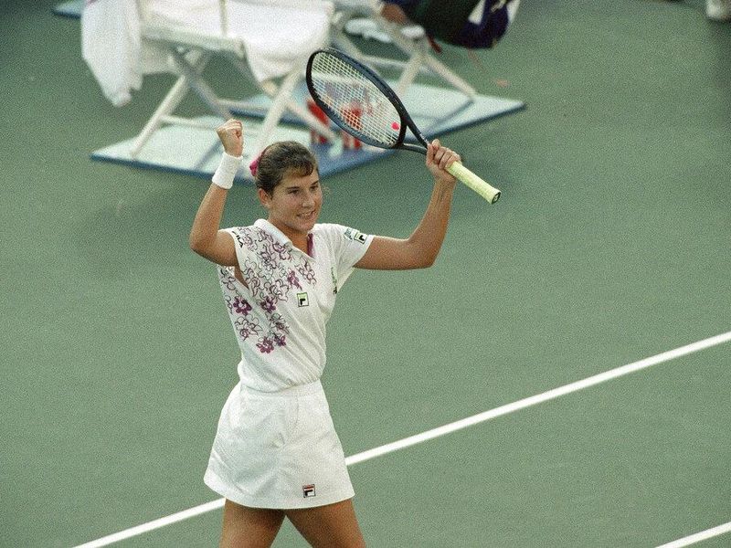 Monica Seles, female tennis great, raises her arms in celebration
