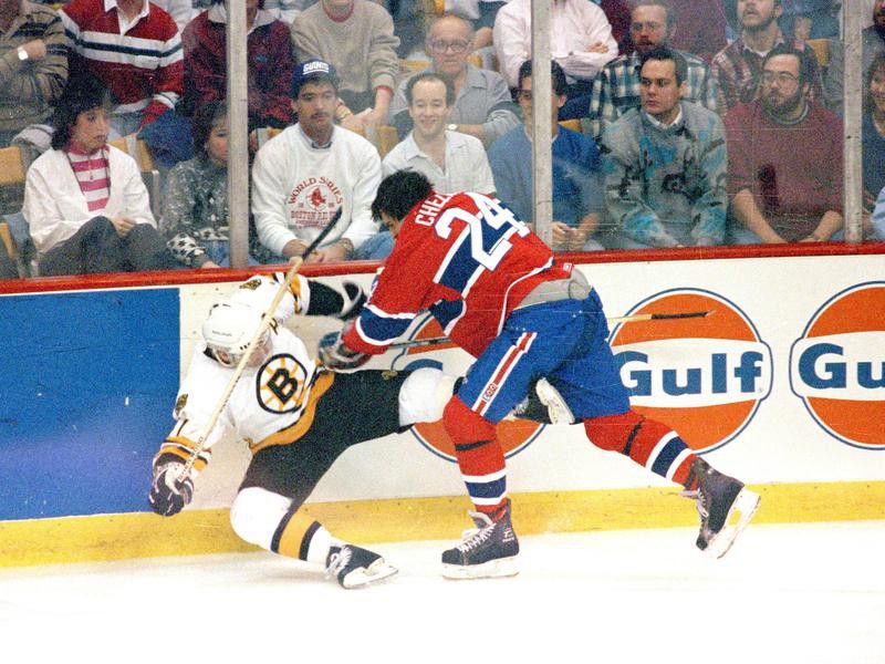 Montreal Canadiens Chris Chelios checks Boston Bruins Steve Kasper into boards