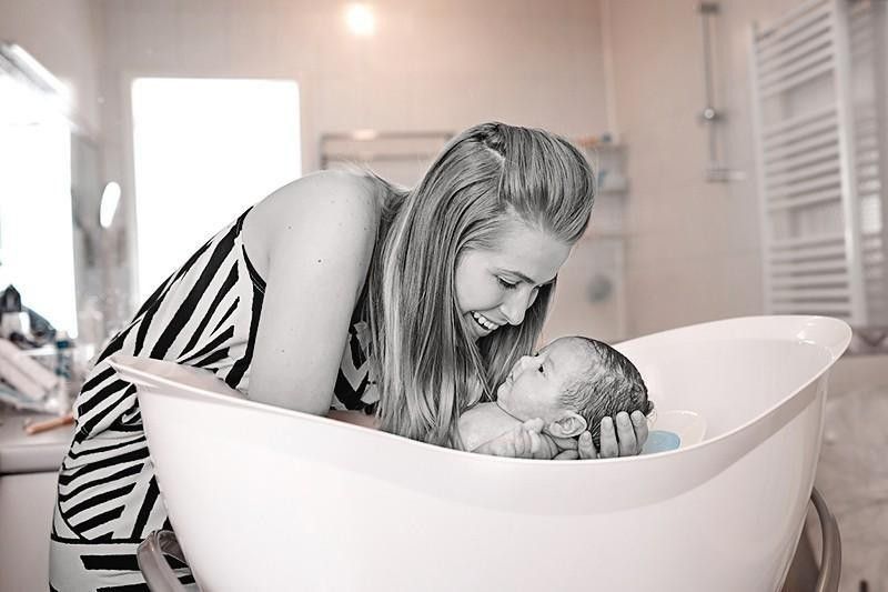 mother bathing baby