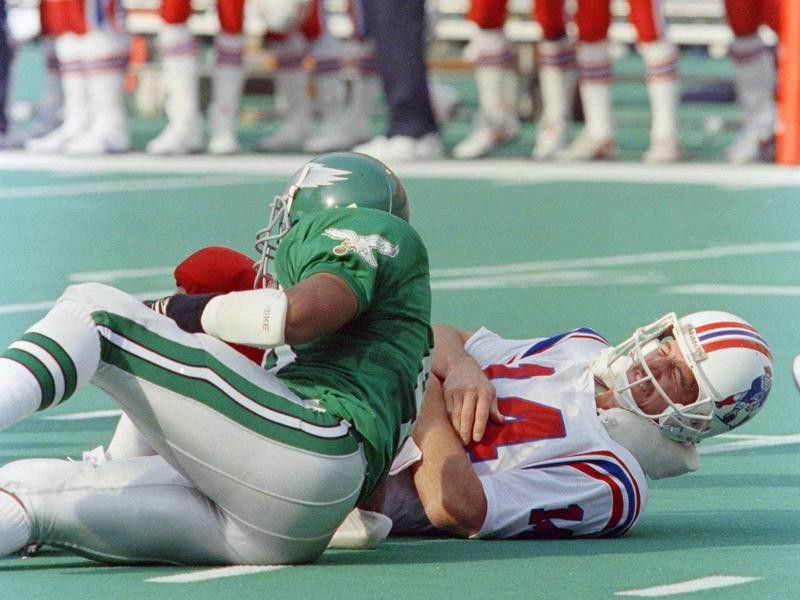 New England Patriots quarterback Steve Grogan grimaces after being hit by Philadelphia Eagles Wes Hopkins