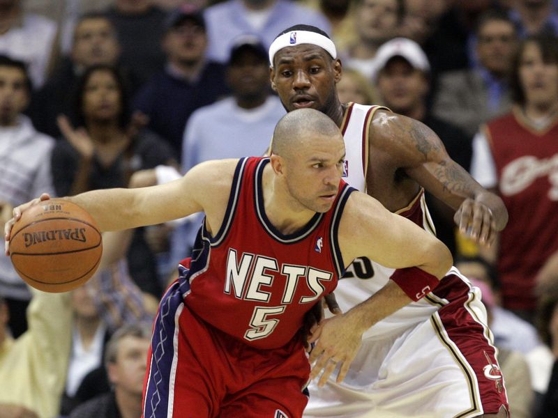 New Jersey Nets' Jason Kidd drives past LeBron James