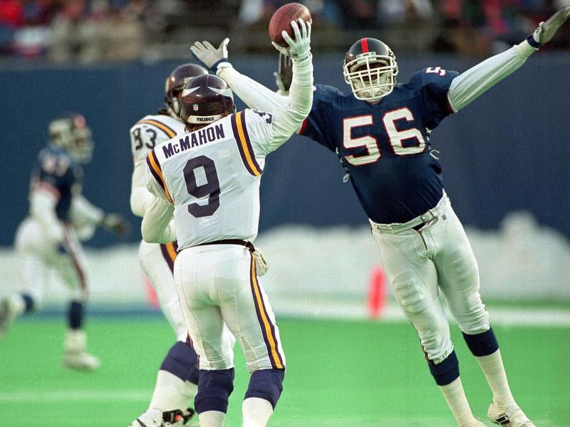 New York Giants' linebacker Lawrence Taylor pressures Minnesota Vikings' quarterback Jim McMahon