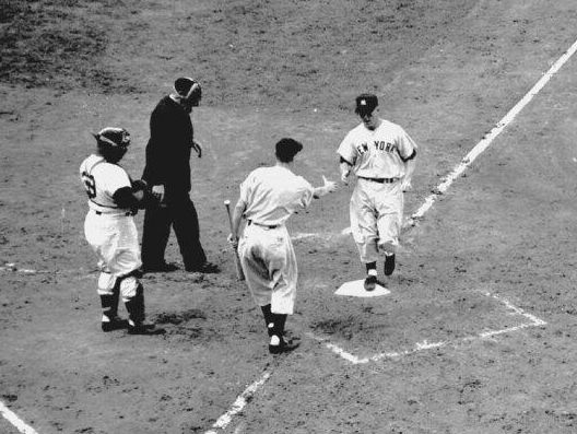 New York Yankees center fielder Mickey Mantle touches home after a home run