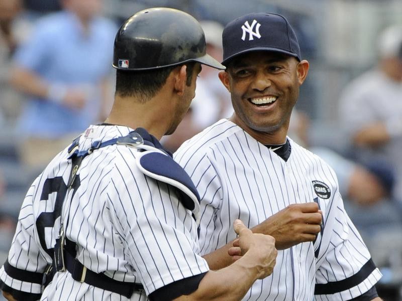New York Yankees closer Mariano Rivera celebrates with Jorge Posada