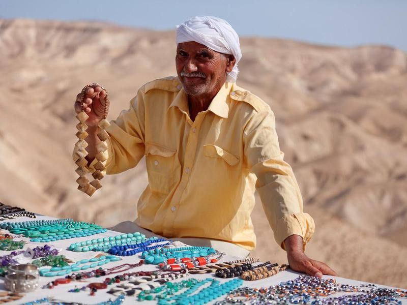 Old bedouin offering a necklace in Israel