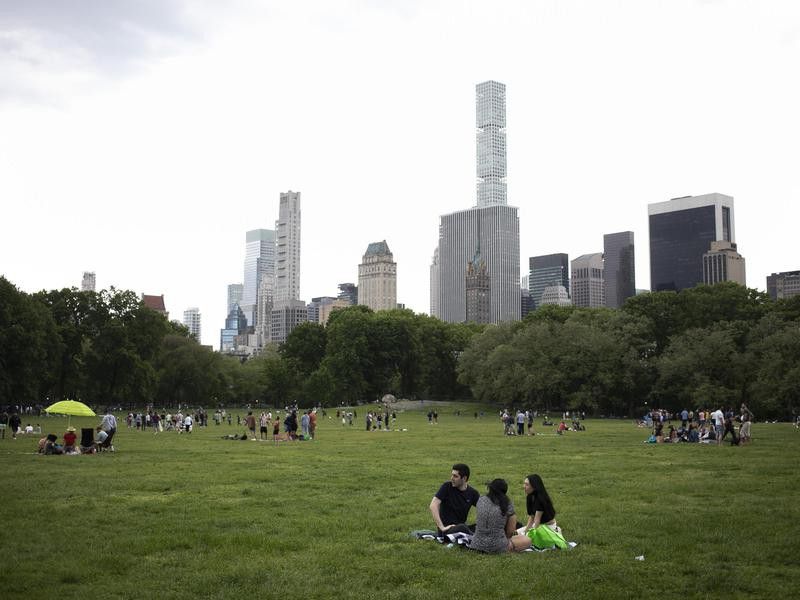 People relaxing in open space in Central Park