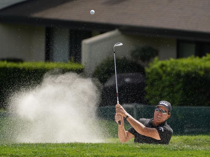 Phil Mickelson follow his shot out of bunker