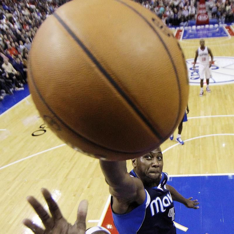 Philadelphia 76ers' Kwame Brown goes up for shot as Dallas Mavericks' Elton Brand defends