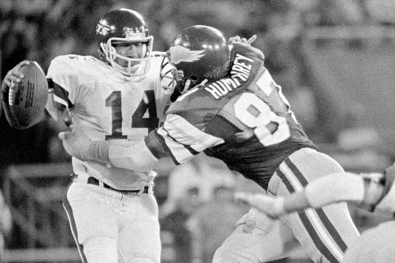 Philadelphia Eagles defensive end Claude Humphrey grabs New York Jets quarterback Richard Todd