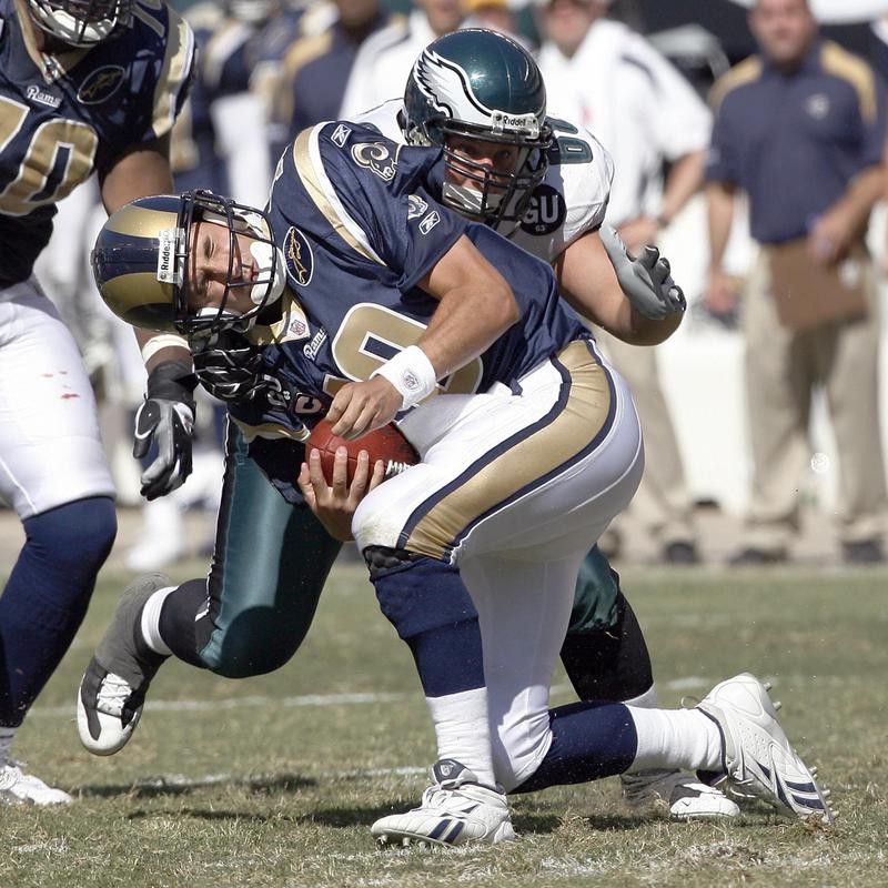 Philadelphia Eagles defensive tackle Dan Klecko wraps up St. Louis Rams quarterback Marc Bulger during football game
