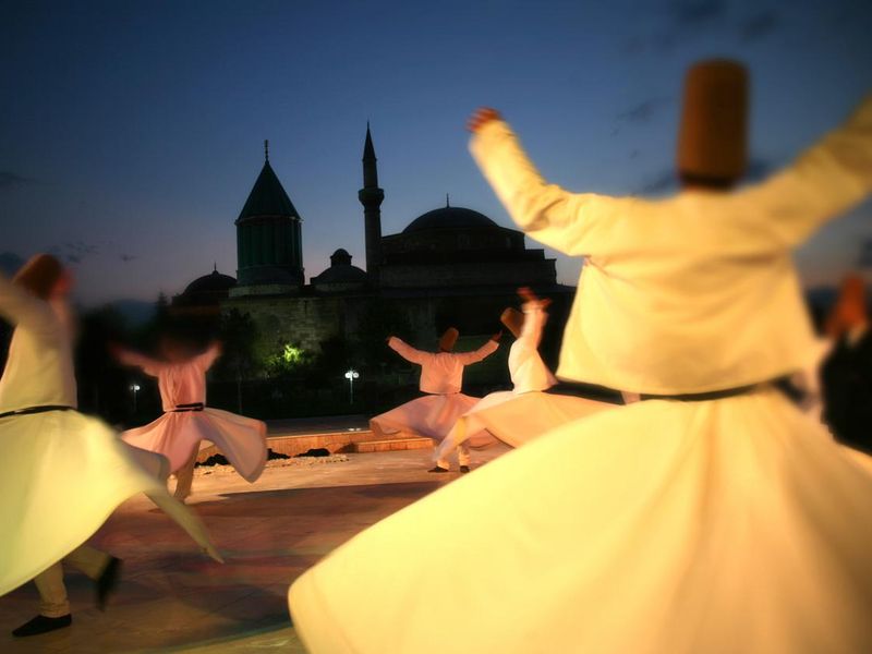Rear view of people dancing outdoors at the Mevlana museum