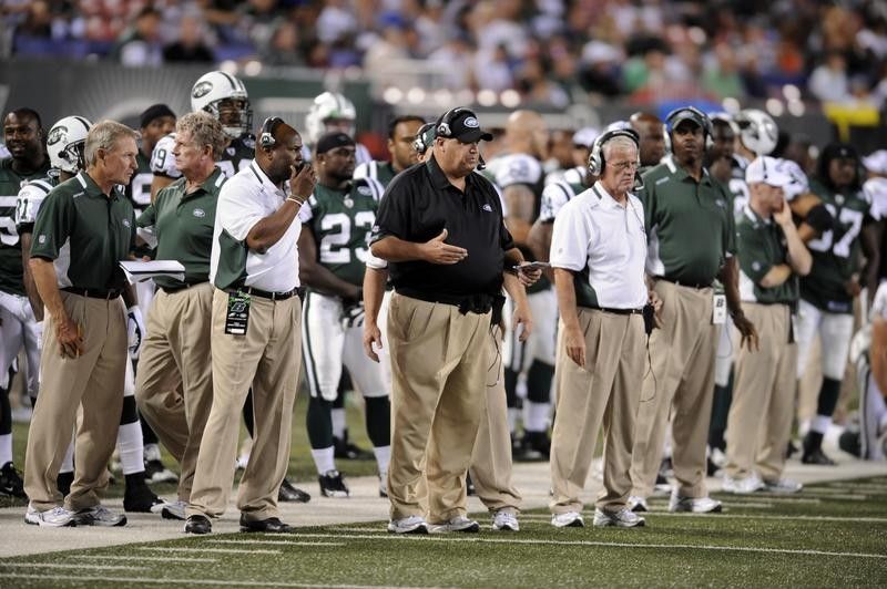 Rex Ryan on the sidelines with  New York Jets players and staff during game against New York Giants