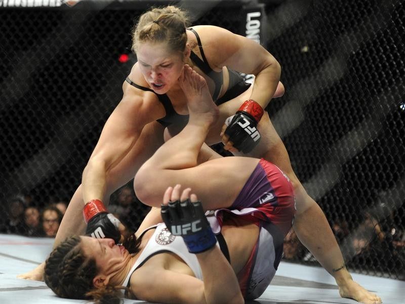 Ronda Rousey punches Miesha Tate of Yakima during UFC mixed martial arts