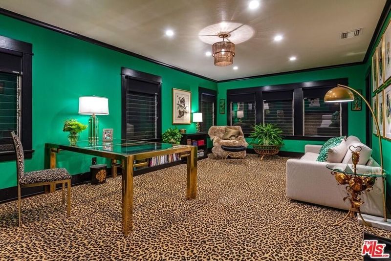Room with green paint and leopard print carpet
