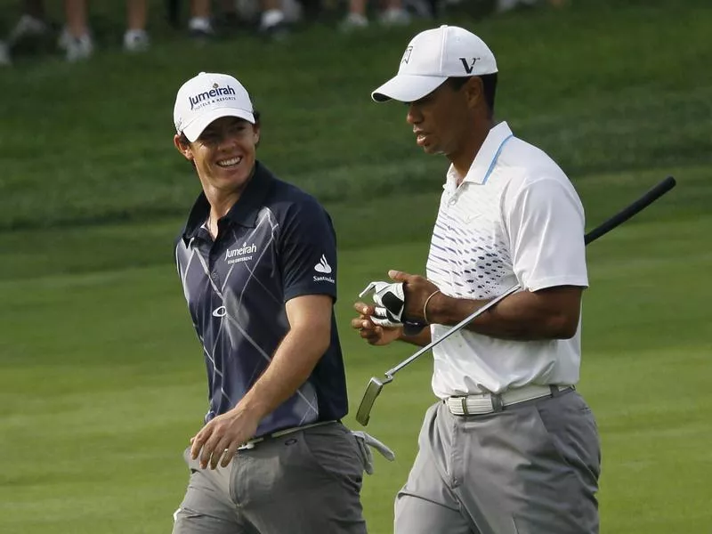Rory McIlroy, left, and Tiger Woods are not talking about golf at the 2012 BMW Championship at Crooked Stick Golf Club in Carmel, Ind.