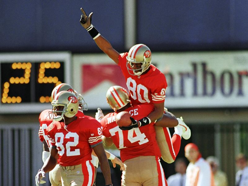 San Francisco 49er Jerry Rice gets ride from tackle Steve Wallace
