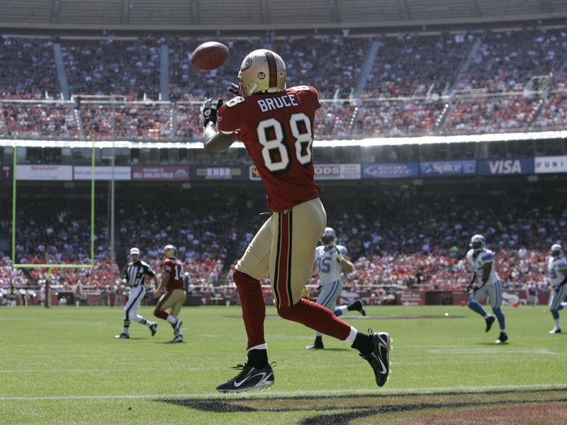 San Francisco 49ers' Isaac Bruce looks to catch pass in NFL football game