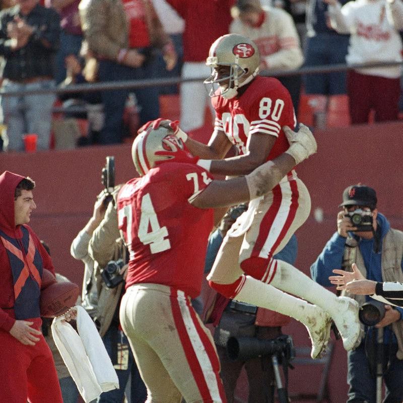San Francisco 49ers wide receiver Jerry Rice celebrates with teammate Steve Wallace