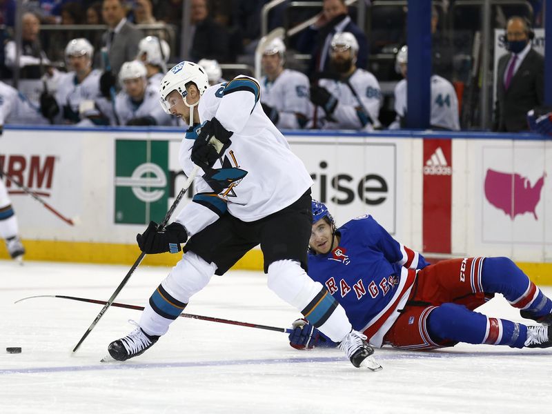 San Jose Sharks' Erik Karlsson avoids New York Rangers' Kevin Rooney