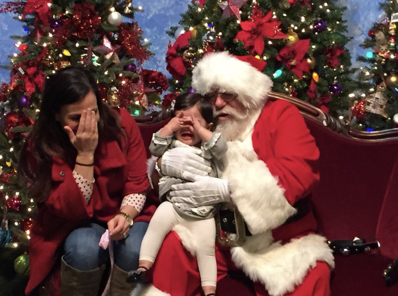 Santa, mom and crying little girl