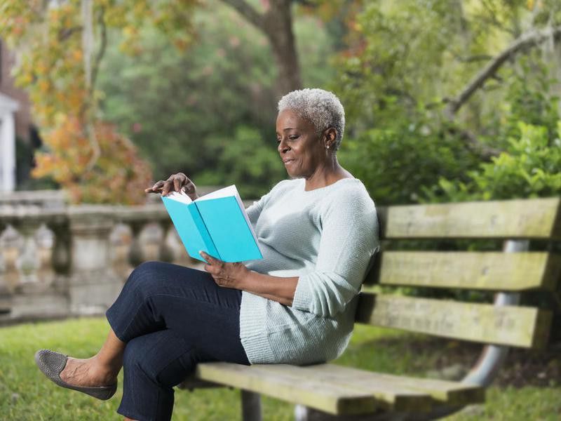 Senior black woman reading a book