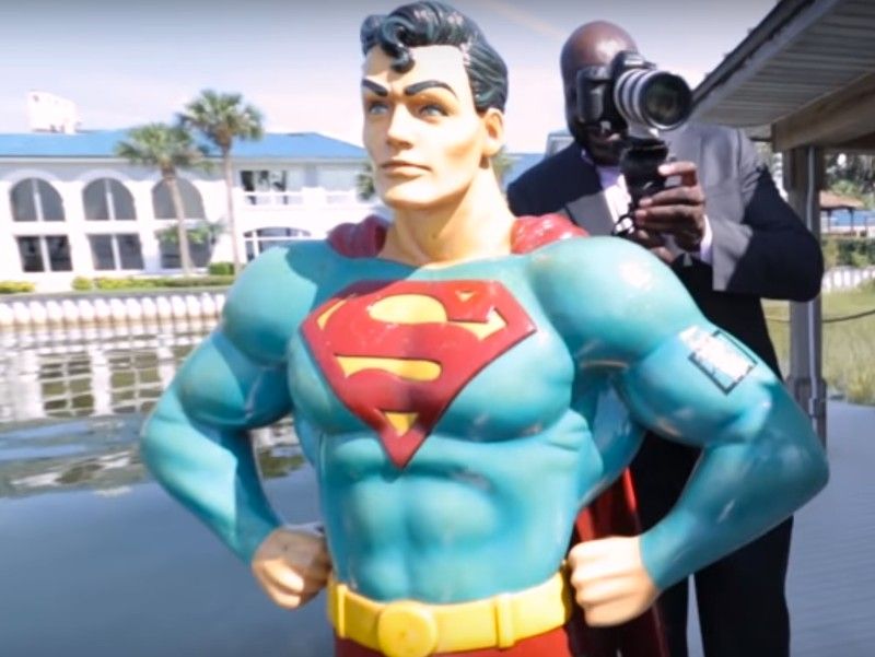 Shaq on his dock with a statue of Superman